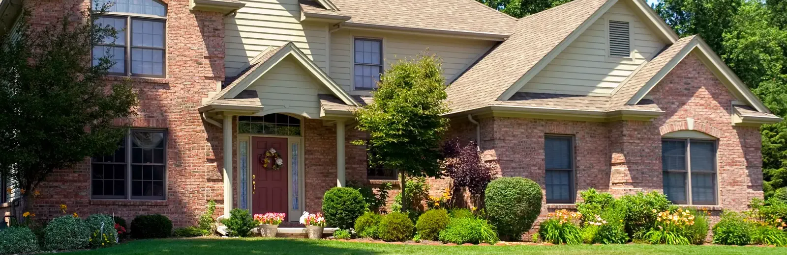 red brick home front lawn